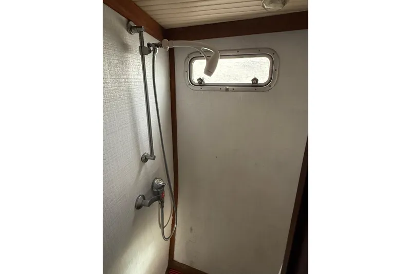 Slide: The Image of 1980 Nauticat Pilothouse shower area with window and adjustable showerhead. - 15