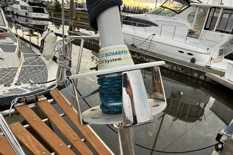 Slide: The Image of 1980 Nauticat Pilothouse sailboat docked, featuring Schaefer System 3100, with nearby yachts. - 16