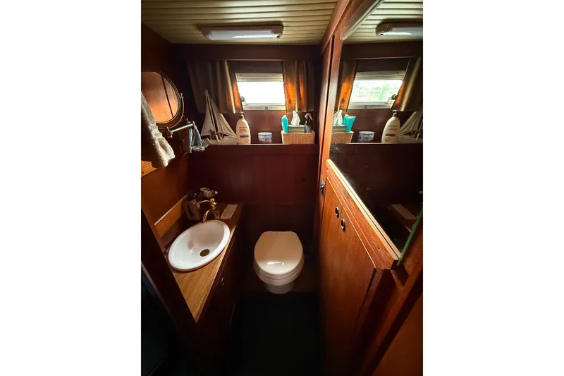 Slide: The Image of 1980 Nauticat Pilothouse bathroom with wooden interior, sink, and toilet. - 18