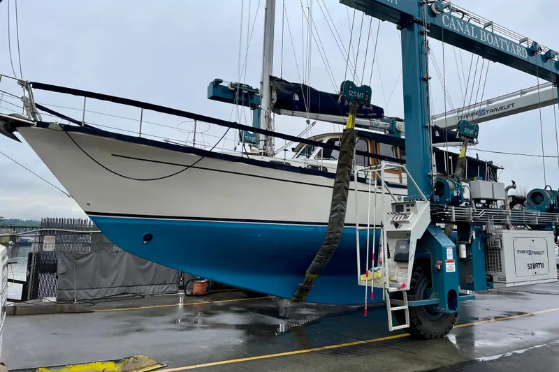 Slide: The Image of 1980 Nauticat Pilothouse sailboat in a boatyard lift, ready for maintenance. - 2