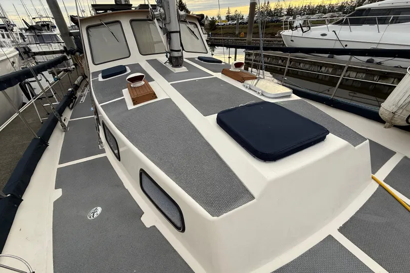 Slide: The Image of 1980 Nauticat Pilothouse sailboat deck with gray non-slip surface, docked at marina. - 24