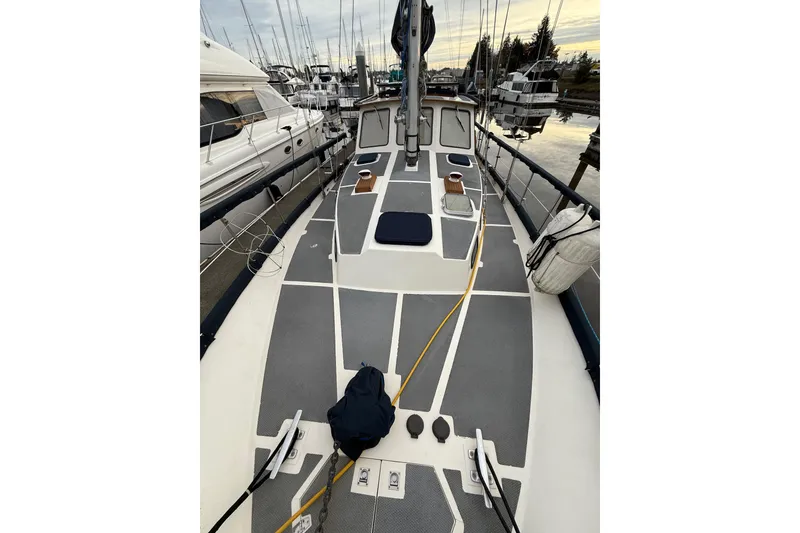 Slide: The Image of 1980 Nauticat Pilothouse sailboat deck view at marina, surrounded by other boats. - 25