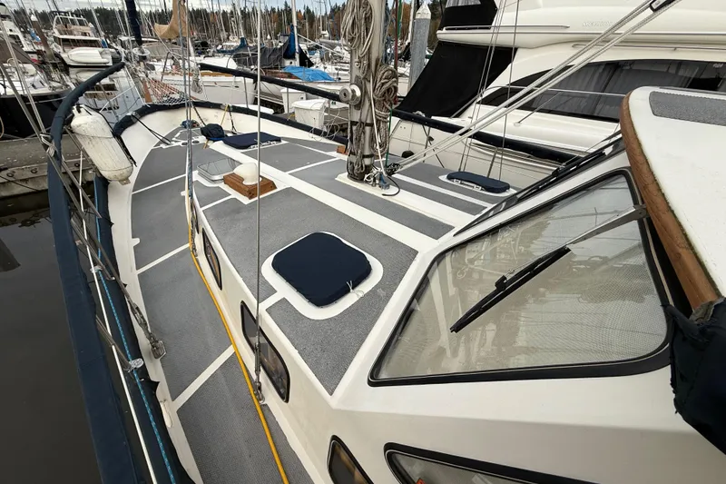 Slide: The Image of 1980 Nauticat Pilothouse sailboat deck view in marina, showcasing sleek design and rigging. - 26