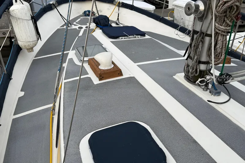 Slide: The Image of 1980 Nauticat Pilothouse sailboat deck with ropes, winch, and fenders in a marina setting. - 27