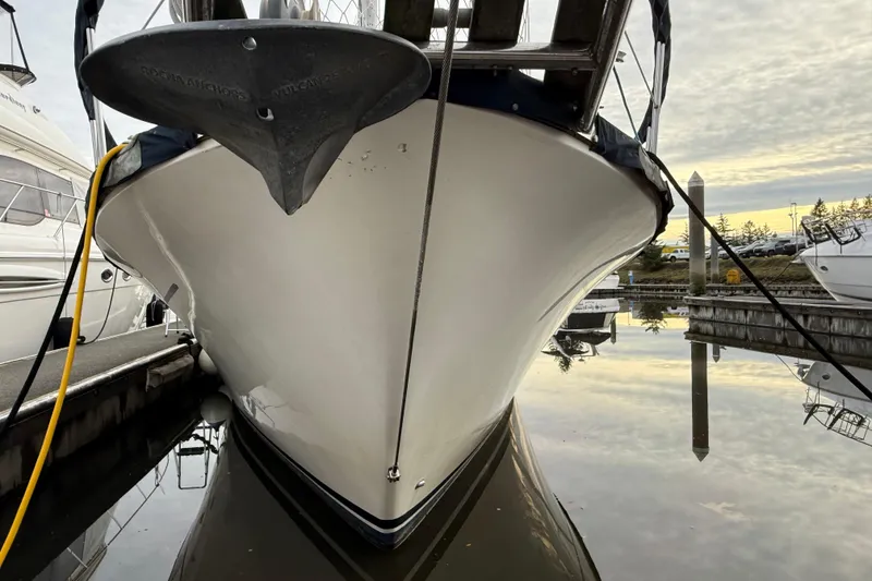 Slide: The Image of 1980 Nauticat Pilothouse boat docked, reflecting on calm water at sunset. - 3