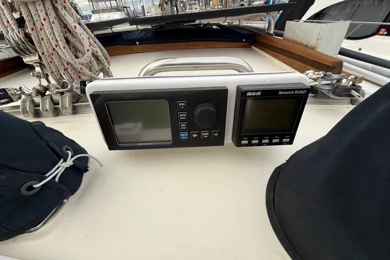 Slide: The Image of 1980 Nauticat Pilothouse sailboat cockpit with navigation instruments and rigging ropes. - 31