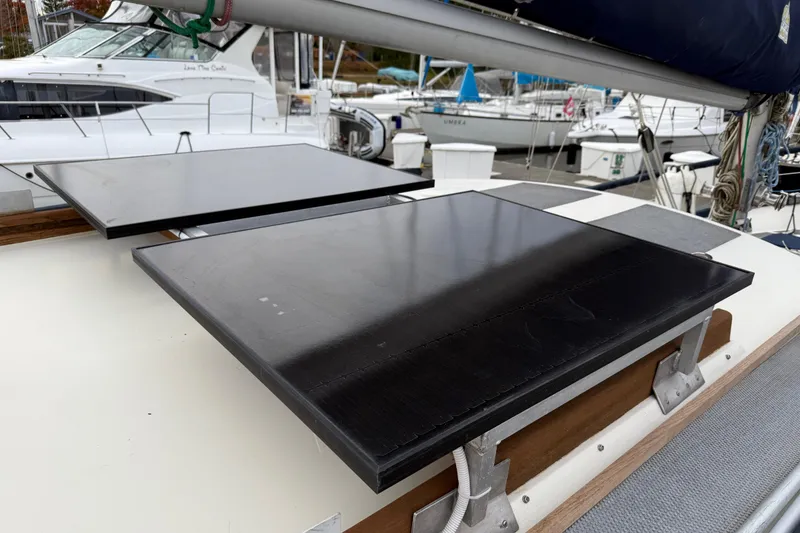 Slide: The Image of 1980 Nauticat Pilothouse sailboat with solar panels on deck, docked at marina. - 34