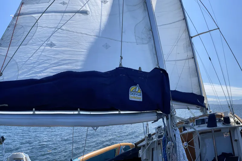 Slide: The Image of 1980 Nauticat Pilothouse sailboat with Doyle sail cover on open water. - 52