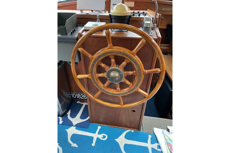 Slide: The Image of Wooden steering wheel of a 1980 Nauticat Pilothouse boat, with nautical decor. - 6