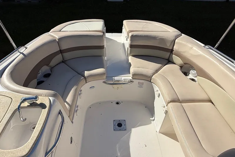 Slide: The Image of 2006 Chaparral 256 SSi boat interior with beige seating and built-in sink. - 1