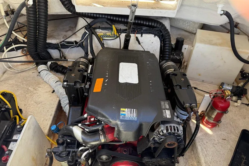 Slide: The Image of Engine compartment of a 2006 Chaparral 256 SSi boat, featuring detailed components and wiring. - 10