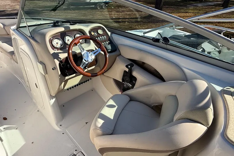 Slide: The Image of 2006 Chaparral 256 SSi boat cockpit with steering wheel and dashboard controls. - 2