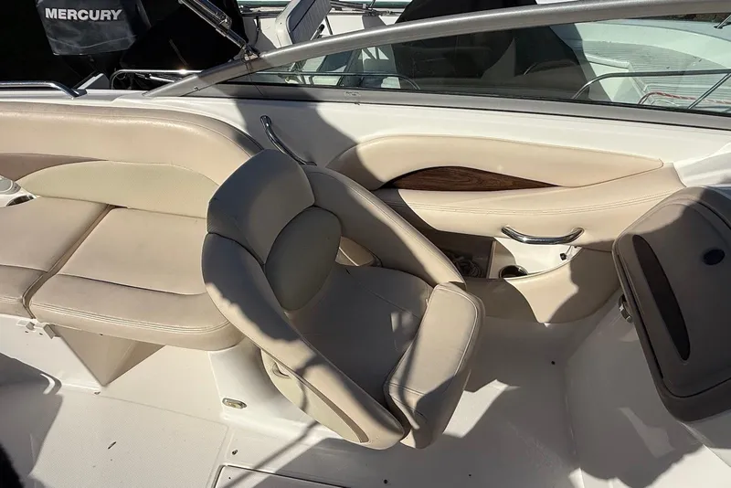 Slide: The Image of 2006 Chaparral 256 SSi boat interior with beige seating and Mercury engine. - 3