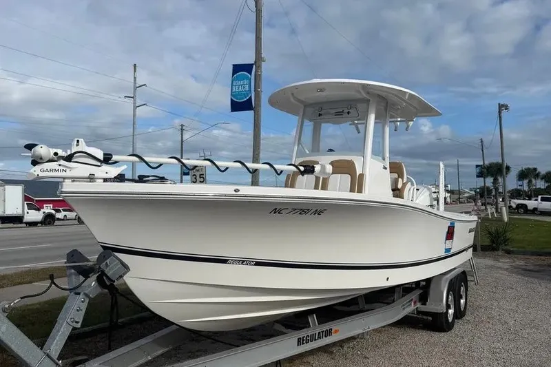 Slide: The Image of 2025 Regulator 26XO boat on trailer, featuring Garmin equipment, parked near Atlantic Beach. - 1