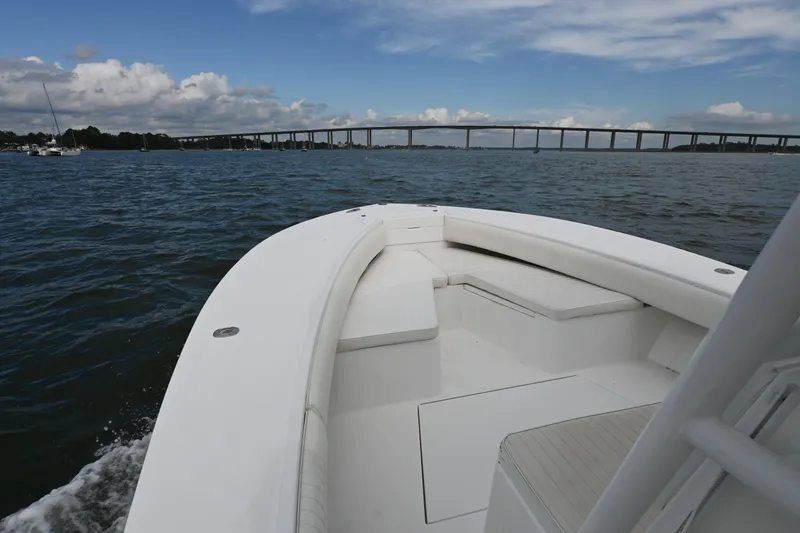 Slide: The Image of 2008 Regulator 32 Forward Seating boat on water with bridge in background. - 10