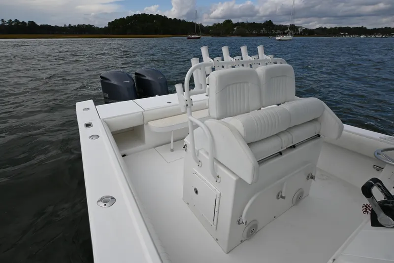 Slide: The Image of 2008 Regulator 32 Forward Seating boat on water, featuring dual engines and white seating. - 12