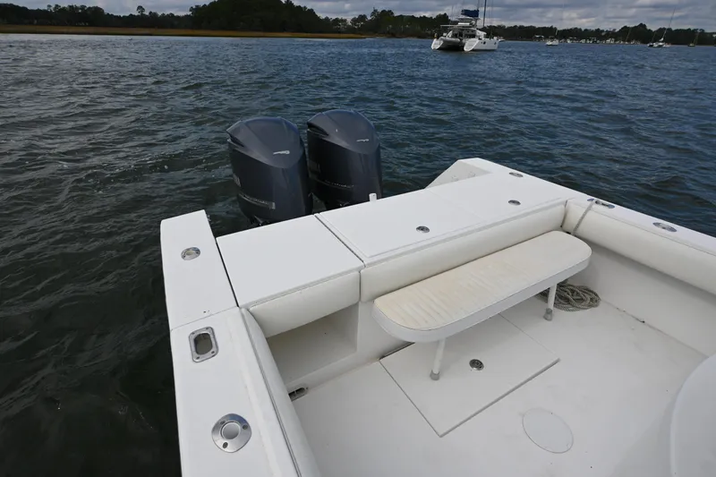 Slide: The Image of 2008 Regulator 32 Forward Seating boat with dual outboard motors on calm water. - 13