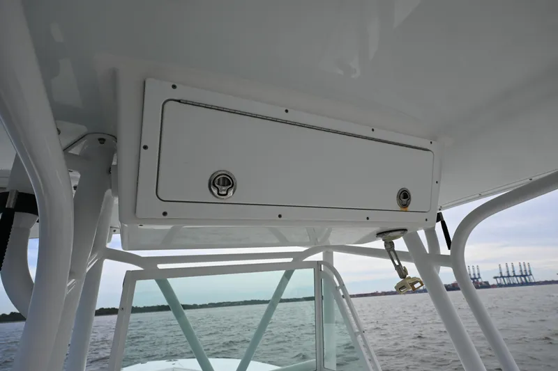 Slide: The Image of 2008 Regulator 32 Forward Seating boat storage compartment, ocean view in background. - 16