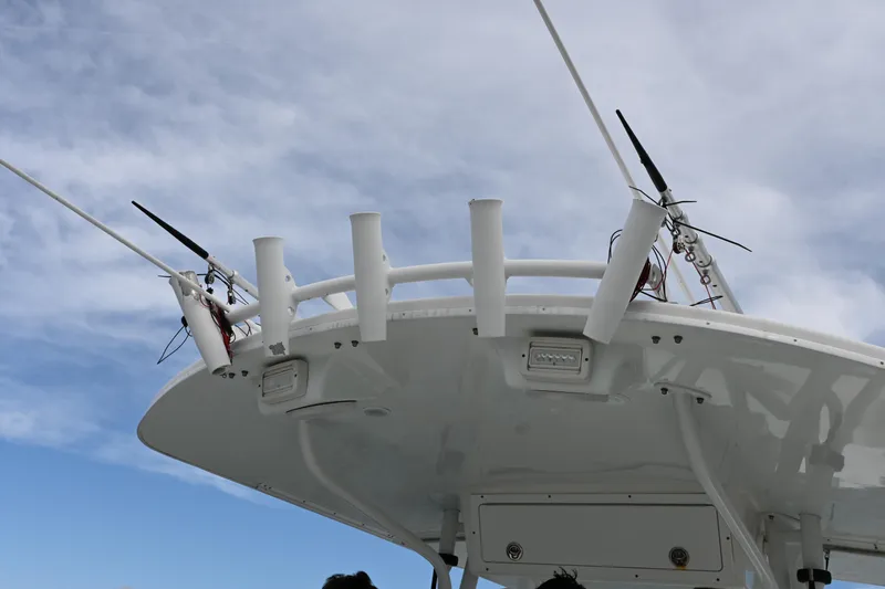 Slide: The Image of 2008 Regulator 32 Forward Seating boat with antennas and rod holders against a cloudy sky. - 17