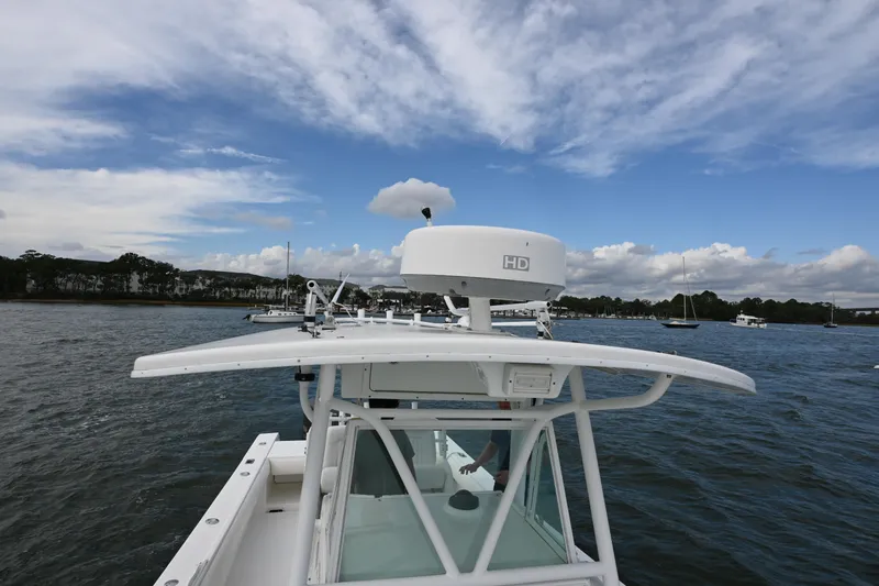 Slide: The Image of 2008 Regulator 32 Forward Seating boat on water under a partly cloudy sky. - 18