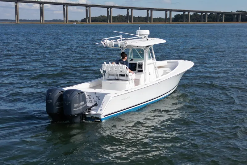 Slide: The Image of 2008 Regulator 32 Forward Seating boat on water with dual Yamaha engines. - 3