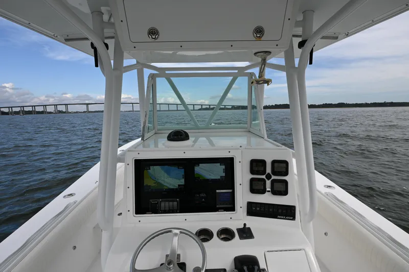 Slide: The Image of 2008 Regulator 32 Forward Seating boat dashboard with navigation system on open water. - 6