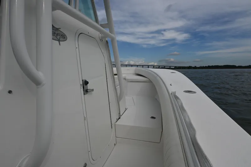Slide: The Image of 2008 Regulator 32 Forward Seating boat on water, showcasing sleek design and spacious deck. - 9
