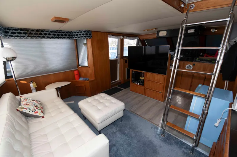 Slide: The Image of Luxurious interior of 1988 Chris-Craft 46 Constellation yacht with modern furnishings and entertainment setup. - 11