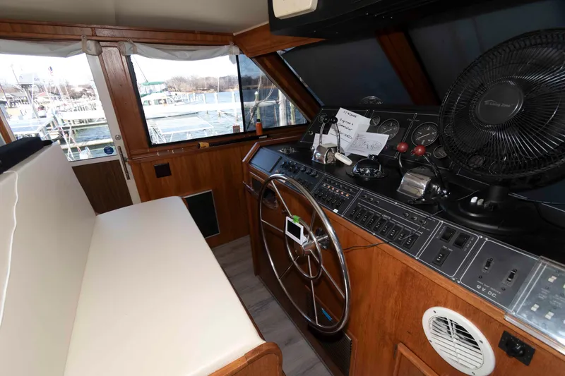 Slide: The Image of Interior helm of 1988 Chris-Craft 46 Constellation yacht with steering wheel and control panel. - 13