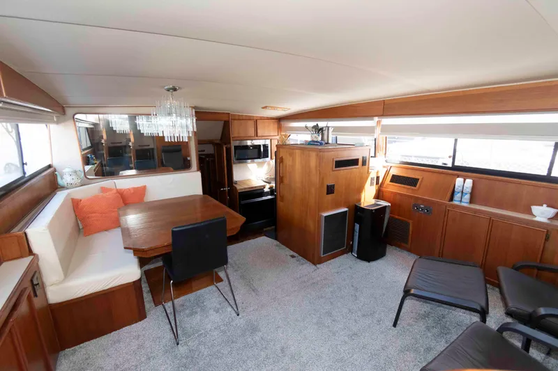 Slide: The Image of Luxurious interior of 1988 Chris-Craft 46 Constellation yacht with elegant dining area. - 14