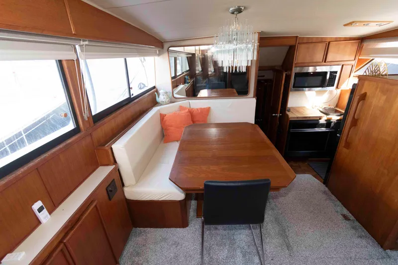 Slide: The Image of Interior of 1988 Chris-Craft 46 Constellation yacht with dining area and kitchen. - 16