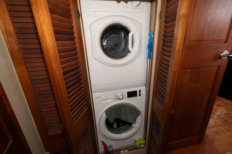 Slide: The Image of Stacked washer and dryer in 1988 Chris-Craft 46 Constellation yacht's wooden closet. - 23