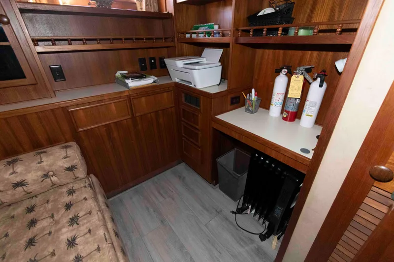 Slide: The Image of Interior of 1988 Chris-Craft 46 Constellation with wood cabinetry and safety equipment. - 27