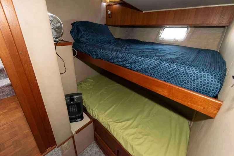 Slide: The Image of 1988 Chris-Craft 46 Constellation cabin with bunk beds and a small fan. - 28