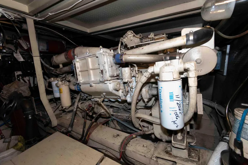 Slide: The Image of Engine room of 1988 Chris-Craft 46 Constellation yacht, showcasing mechanical components. - 30