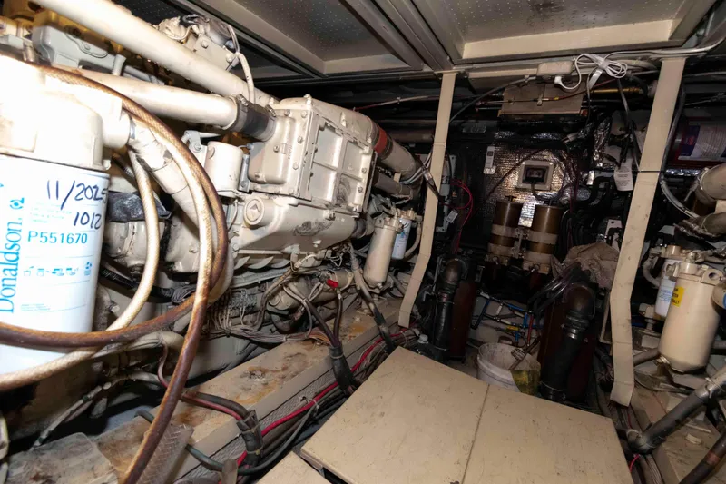 Slide: The Image of Engine room of 1988 Chris-Craft 46 Constellation yacht, showcasing mechanical components and wiring. - 31