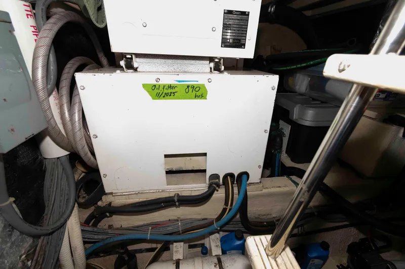 Slide: The Image of Engine room of 1988 Chris-Craft 46 Constellation with oil filter details. - 32