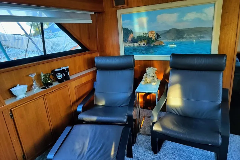 Slide: The Image of 1988 Chris-Craft 46 Constellation yacht interior with white seating and panoramic windows. - 6