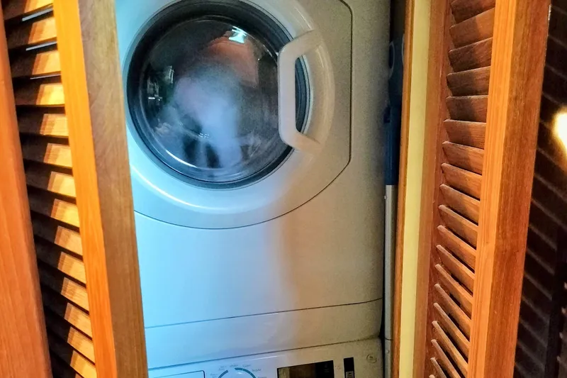 Slide: The Image of Interior of 1988 Chris-Craft 46 Constellation with white sofa, orange pillows, and blue carpet. - 9