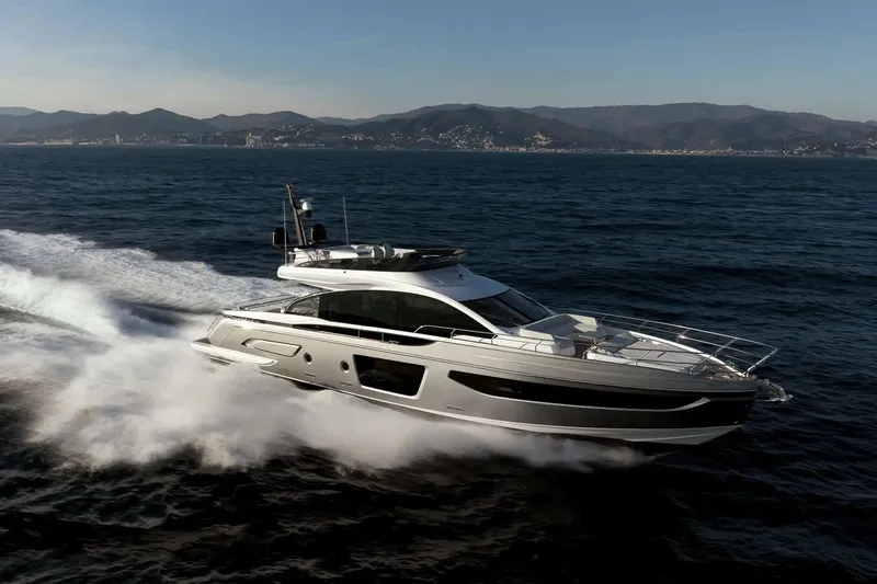 The Image of 2019 Azimut S7 yacht cruising on open sea with scenic mountain backdrop. - 1