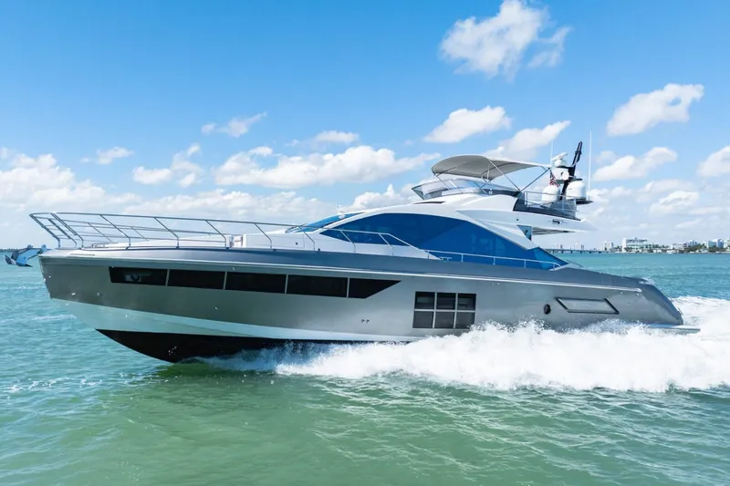 Slide: The Image of 2019 Azimut S7 yacht cruising on open water under a clear blue sky. - 2