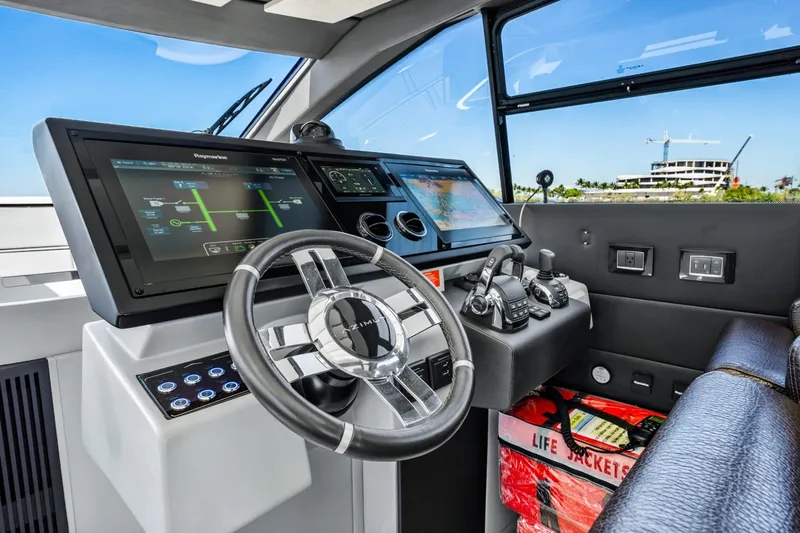Slide: The Image of 2019 Azimut S7 yacht helm with advanced navigation displays and controls. - 25
