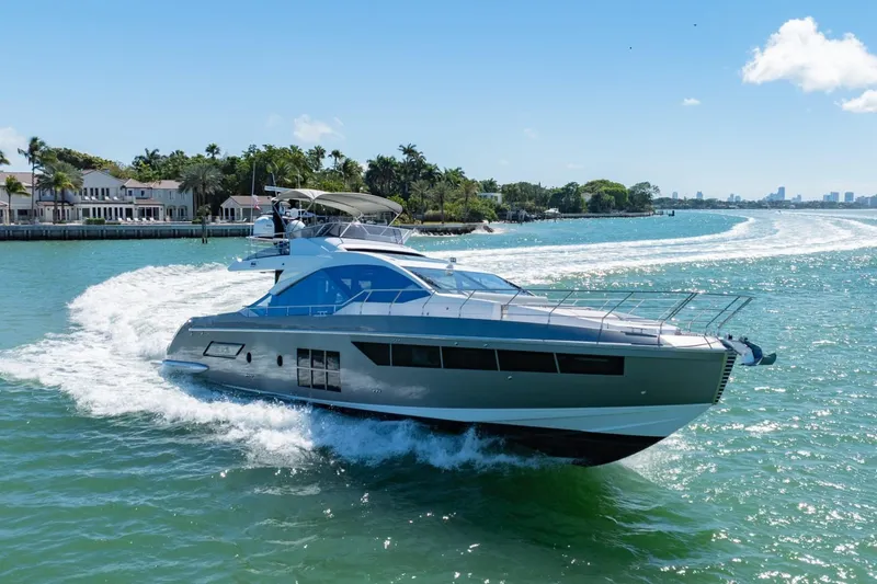 Slide: The Image of Luxurious 2019 Azimut S7 yacht cruising on a sunny day near waterfront homes. - 5