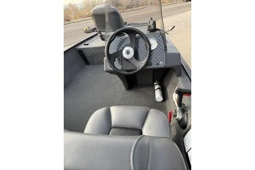 Slide: The Image of 2025 Tracker Bass Tracker Classic XL boat interior with steering wheel and seating. - 3