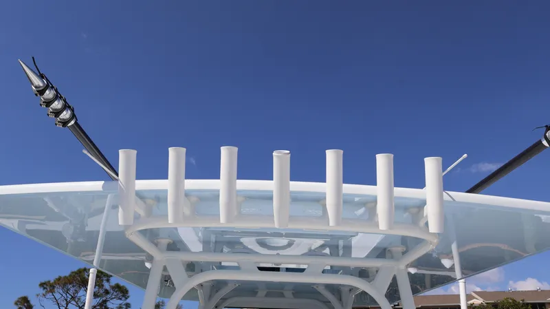 Slide: The Image of 2025 Yellowfin 39 Offshore boat with rod holders against clear blue sky. - 35