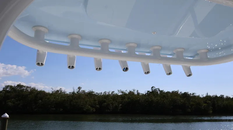 Slide: The Image of 2025 Yellowfin 39 Offshore boat rod holders against a clear sky and water backdrop. - 36