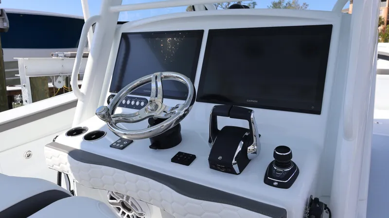 Slide: The Image of 2025 Yellowfin 39 Offshore boat dashboard with dual screens and steering wheel. - 40