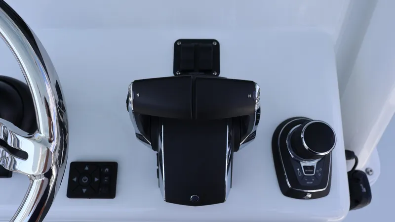 Slide: The Image of Control panel of 2025 Yellowfin 39 Offshore boat with steering wheel and throttle. - 42