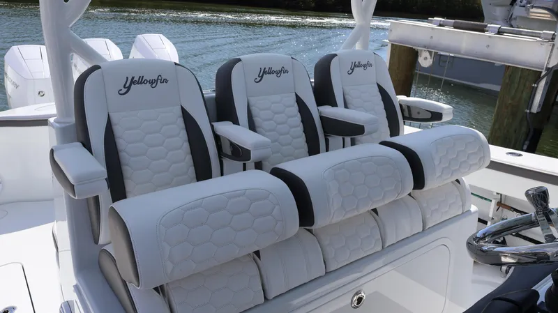 Slide: The Image of 2025 Yellowfin 39 Offshore boat seats, featuring luxurious white and black upholstery. - 46