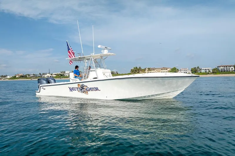 The Image of 2014 SeaVee 34 boat on water, American flag, coastal background. - 0